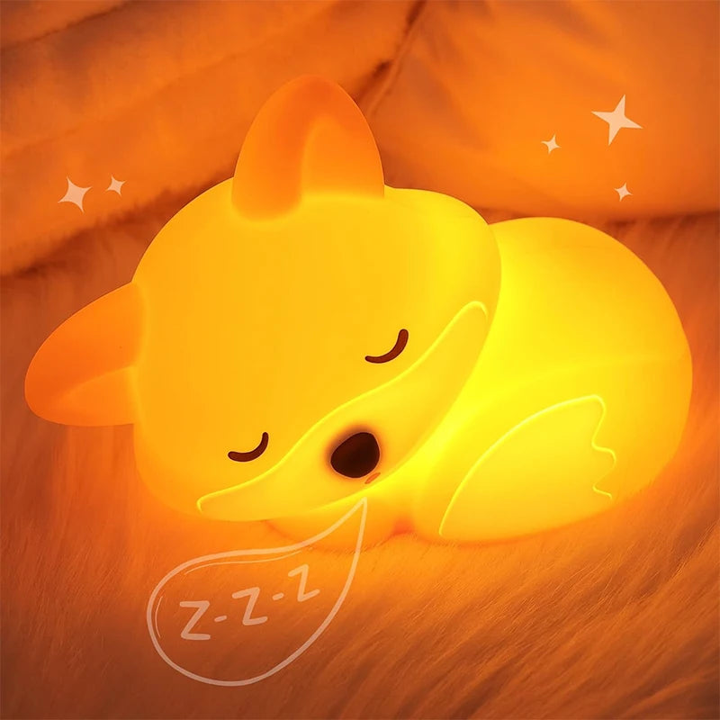 Fox silicone night light glowing orange on nightstand